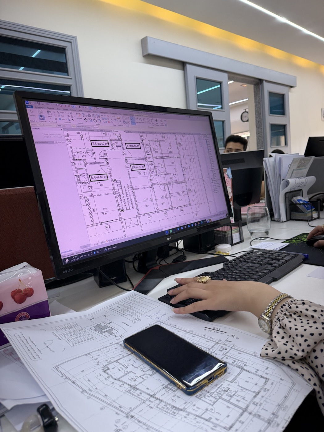BIM model and printed technical drawings being reviewed at LINE